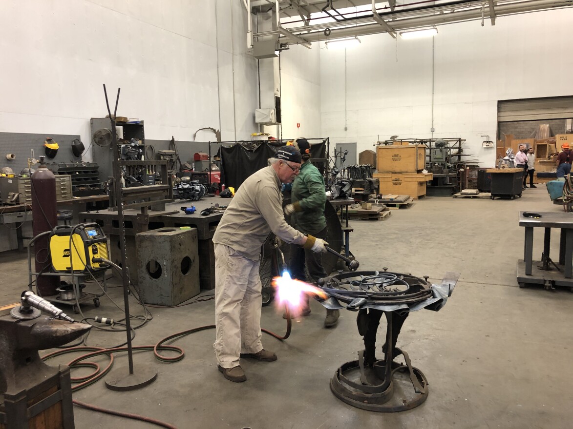 Albert Paley working on a metal table sculpture